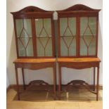 A pair of 19th Century Satinwood Cabinets fitted pair of glazed doors above serpentine fronted bases