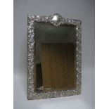 A large Edward VII silver framed Easel Mirror with floral and scroll embossing, bevelled plate,