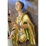 A carved and painted giltwood Figure of St Dorothea on scroll base, 3ft H, titled