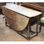 An 18th Century Gateleg Table, the twin flap oval top above a ring turned legs & square stretchers