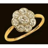 A Diamond Cluster Ring rub-over set old-cut stone within seven smaller stones