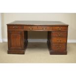 A 19th Century oak Partner's Desk with dark green inset leather writing surface above twelve drawers