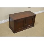 An 18th Century oak Table Cabinet with dentil frieze above pair of solid panelled doors enclosing