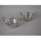 A pair of George V silver pierced oval two handled Baskets on scroll feet, London 1925, 10 x 6in,