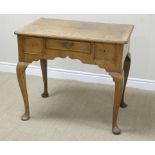 An 18th Century walnut veneered Lowboy fitted three drawers above a shaped frieze on cabriole