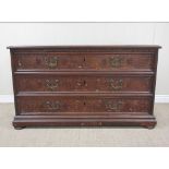 An 18th Century Continental oak and walnut Chest of three long drawers with marquetry inlaid leafage