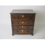 A 19th Century walnut Apprentice Piece Sewing Chest with hinged lid above one dummy and three long