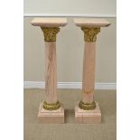 A pair of 19th Century French pink veined Columns with gilt bronze mask and scroll mounts and