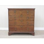 An 18th Century oak Chest of two short and three long drawers having feather banding on bracket