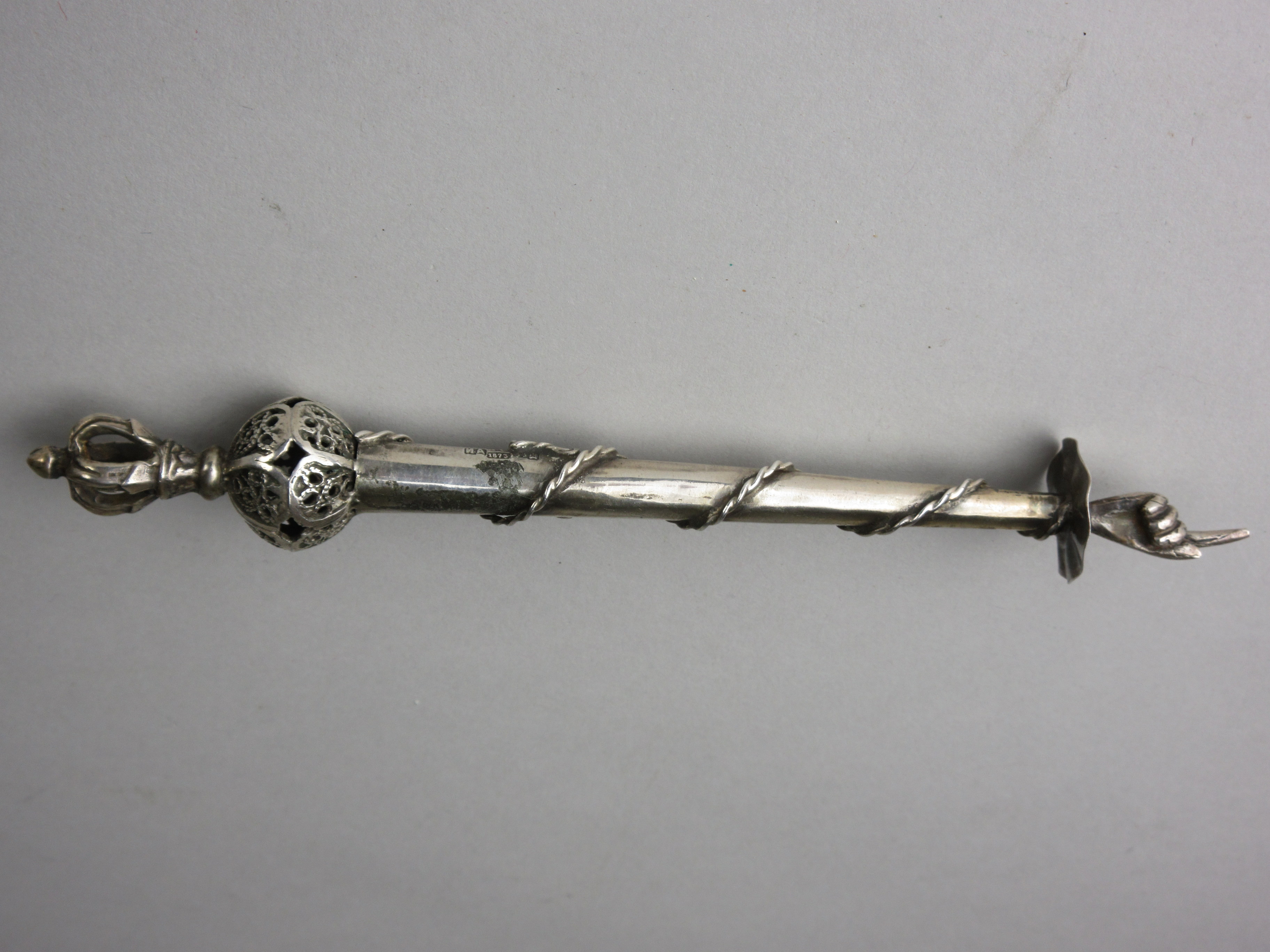 A Russian silver Torah Pointer of tapered form with coronet and pierced orb surmount, tapering shaft