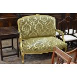 A gilt framed Settee with floral crest, green floral upholstery on cabriole supports, 4ft W