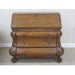 An 18th Century Dutch pine Bureau with interior drawer and pigeon holes, the bombé front fitted