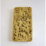 A 19th Century Chinese deep carved ivory Card Case depicting numerous figures in a landscape, 3 1/