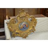 A carved giltwood scroll Cartouche painted coat of arms with motto, 2ft 8in W