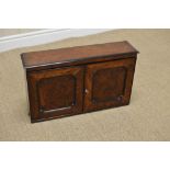 A 19th Century burr yew small Cabinet with pair of solid panelled doors having ebonised leafage