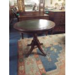 A Tooled Green Leather Topped Oak Pub Table with Claw Feet Culminating in Casters,