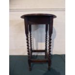 An Edwardian Oak Circular Top Occasional Table with Barley Twist Supports,