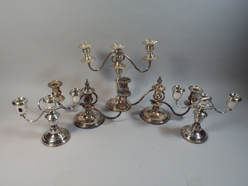 Two Pairs of Silver Plated Three Branch Candelabra and A Single Example