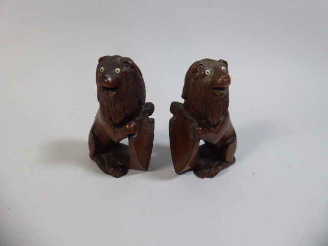 A Pair of Carved Colonial Hardwood Studies of Lions with Shields,