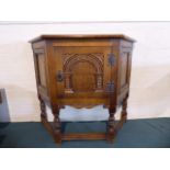 An Edwardian Oak Credence Cabinet with Carved Panel Door,