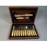 An Edwardian Oak Canteen of Bone Handled Fish Knives and Forks,