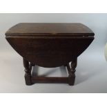 A Small Oak Oval Topped Drop Leaf Coffee Table,