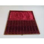 An Edwardian Oak Ring Box with 77 Inner Compartments,