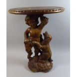 An Unusual Moulded Plastic Circular Stand the Support in the Form of Cherub with Dog,