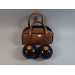 A Pair of Cased Lawn Bowls,