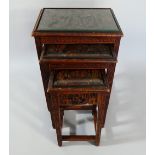 A Nest of Three Glass Topped Oriental Carved Wooden Tables.