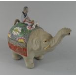 An Oriental Glazed Earthenware Teapot Modelled as an Elephant with Trunk in Salute.