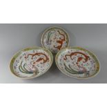Three Chinese Plates decorated with Red Dragon and Phoenix, Yellow Key Border.