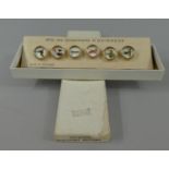 A Boxed Set of Six Vintage Gilt Metal and Glass Guinness Waistcoat Buttons