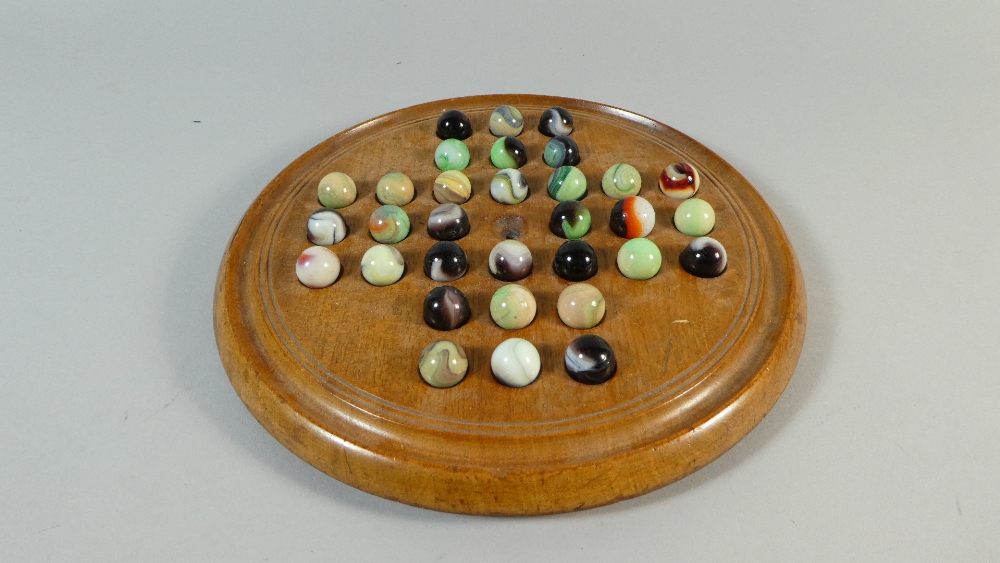 A Late 19th/Early 20th Century Solitaire Game Fruitwood Base and Multicoloured Glass Marbles. 22.