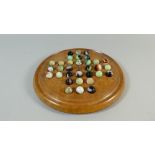 A Late 19th/Early 20th Century Solitaire Game Fruitwood Base and Multicoloured Glass Marbles. 22.