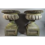 A Pair of Reconstituted Campana Garden Planters on Square Pedestal Base.