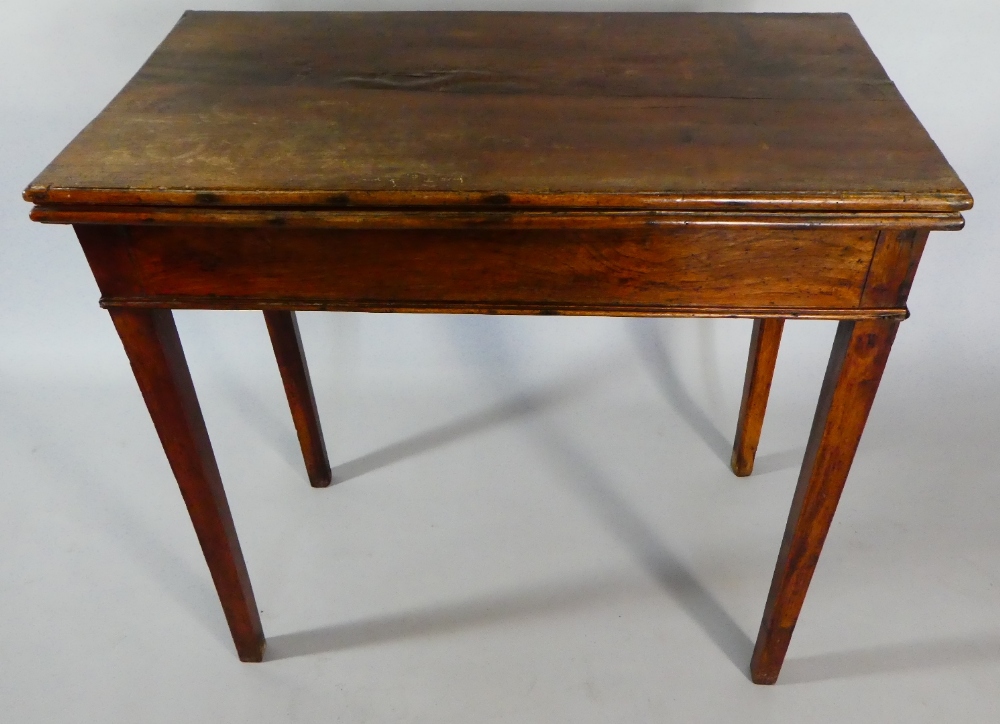 An 18th Century George III Country Made Walnut Tea Table with a Folding Top over Square Tapering