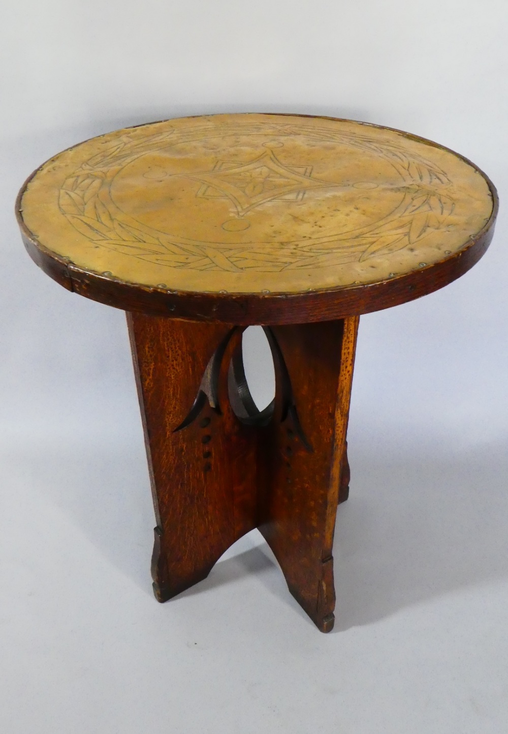 A Late 19th Century Arts and Crafts Oak Liberty Style Centre Table with an Engraved Brass Top over