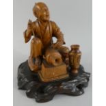 An Oriental Carved Boxwood Figure of an Elderly Metalworker, Hand Etching Vases.