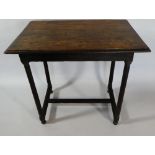 An Early 18th Century Country Made Oak Centre Table with a Plank Top supported on Turned Legs and H