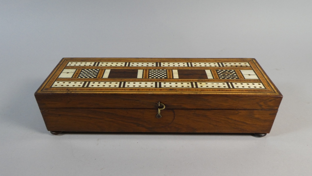 An Early 19th Century Rosewood Games Box.. The Top with an Inlaid Cribbage Board.