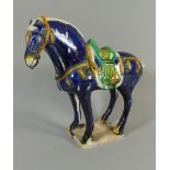 A Chinese Model of a Sancai Tang Horse. Decorated in Blue Green and Yellow Enamels. Some Damage. 22.