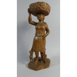An Early Arts and Crafts Carved Oak Figure of a Woman Carrying Basket with an Attendant Child and
