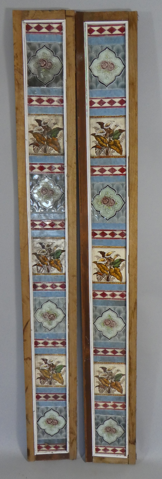 Two Wooden Framed Panels Decorated with Floral Tiles.