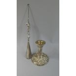 A Silver Handled Shoe Horn/Button Hook and a Silver Candlestick