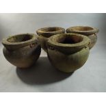 A Set of Four Terracotta Campana Style Circular Planters with Scrolled Handles