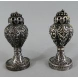 A Pair of Pretty White Metal Pepper Pots of Lobed Form with Foliate Decoration in Relief.