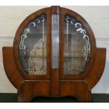 A Walnut Art Deco Circular Alarm Clock Shaped Display Cabinet with Gilt and Silvered Decoration to