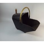 A Brass Mounted Toleware Helmet Shaped Coal Scuttle with Shovel,