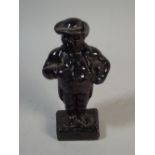 A Small Cast Iron Door Stop in The Form of A Portly Gent,
